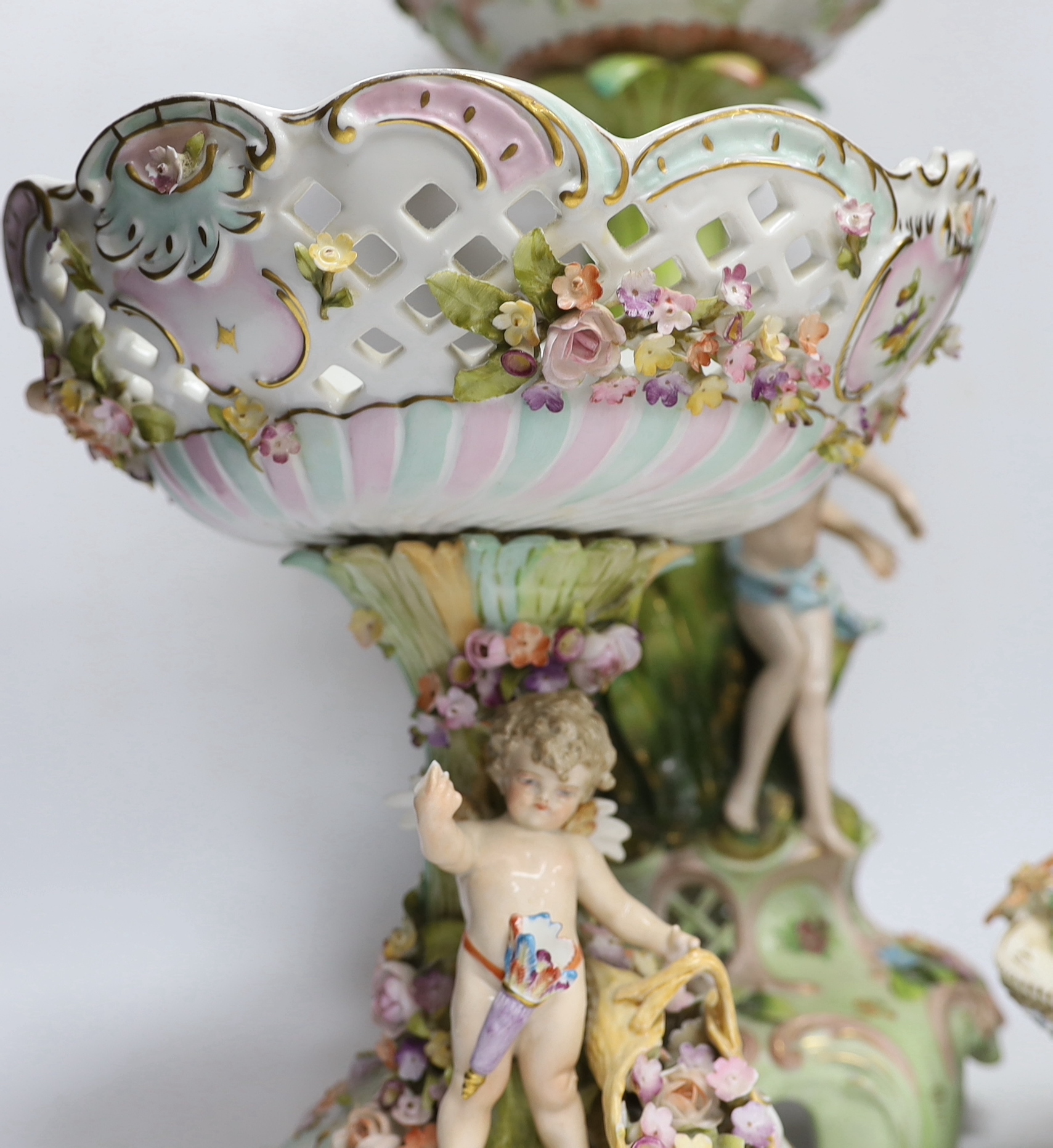 A Sitzendorf figural centrepiece, a smaller similar centrepiece and an English porcelain basket, tallest 54cm